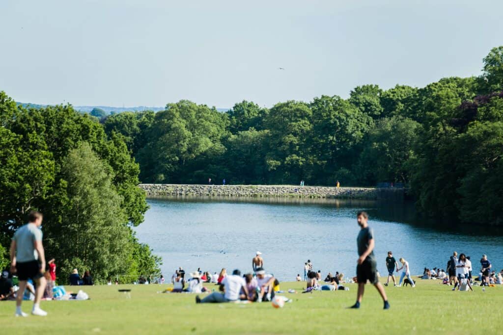 People walking and having picnics in Roundhay Park, Leeds.